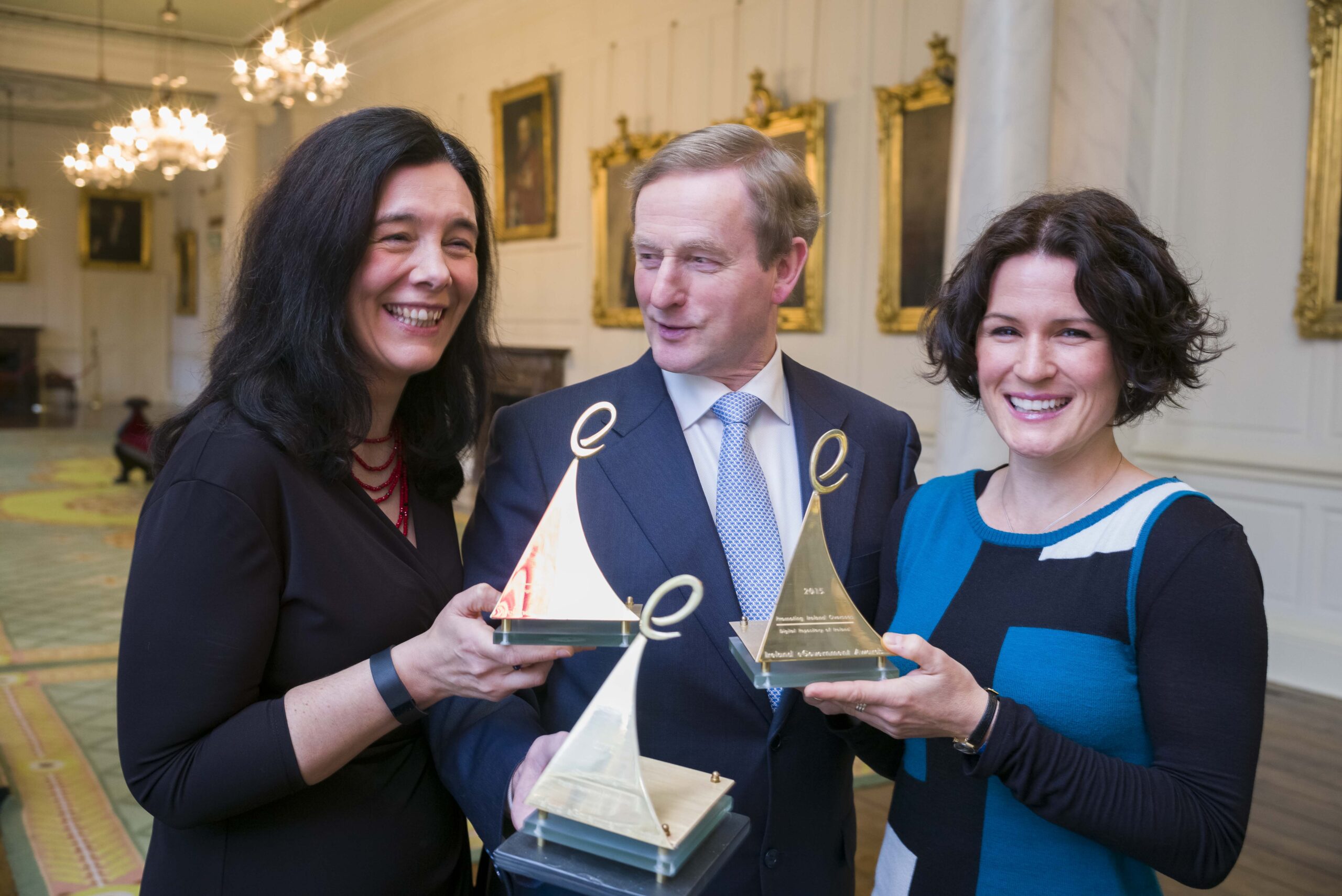 Photo free to use;<br />Business:<br />
29/01/15;<br />
An Taoiseach Enda Kenny TD, presented (L) Dr Sandra Collins and (R)Dr Natalie Harrower, of The Digital Repository of Ireland (DRI) today the Overall Award for the ‘Inspiring Ireland’ project at the 2014 eGovernment Awards. The DRI, which is the national digital storage location for Ireland’s social and cultural data, was also crowned winner of the Open Source Award, and the Promoting Ireland Overseas Award.<br />
 <br />
Sponsored by eircom Business Solutions, the Awards are jointly run by the Public Sector Times and digital marketing company Elucidate.;<br />
Photo: John T Ohle Photography;<br />
For more information: Eilish Joyce, FleishmanHillard E: Eilish.joyce@fleishmaneurope.com M: +353 87 791 4641
