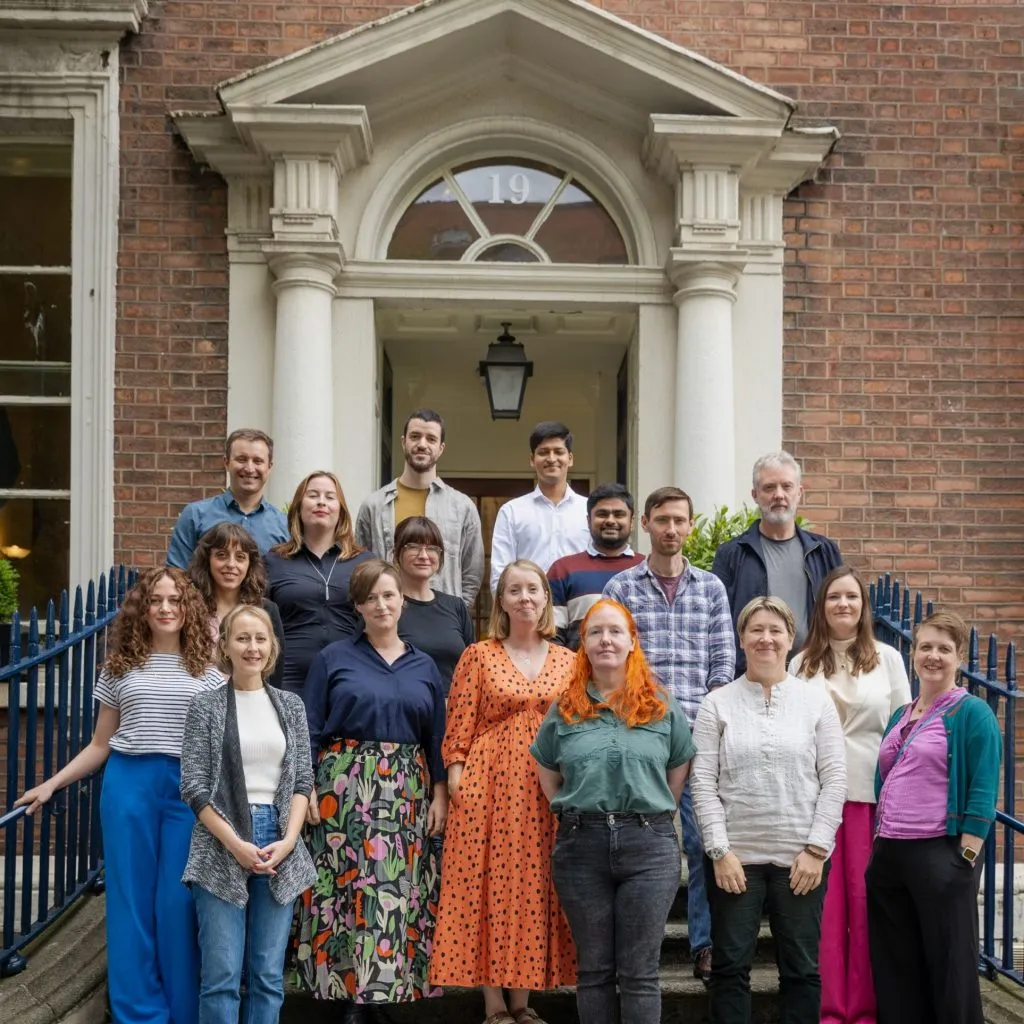 Colour photo of the DRI team standing on the steps outside the Royal Irish Academy