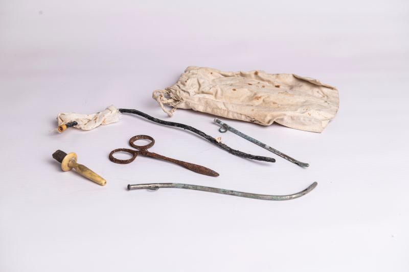Medical instrument from the midwife's bag used by Mary Ann Fanning early in her career: Small cotton bag with instruments including episiotomy scissors.