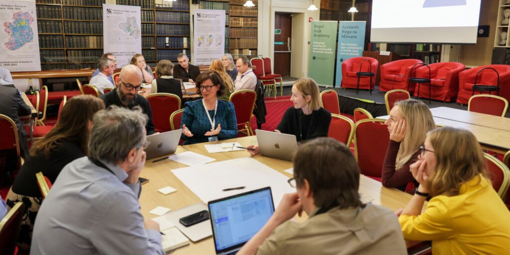 Attendees of the NORF Workshop sitting at tables in the Meeting Room of the Royal Irish Academy, discussing the topics of the day.