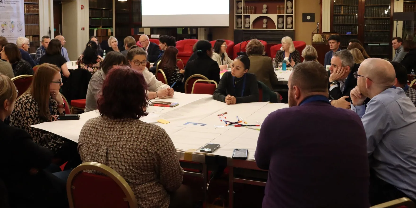 Attendees of the 'Reform of Research Assessment: Impact on Doctoral Students' workshop sitting at discussion tables in the Meeting Room of the Royal Irish Academy on 5 November 2024.