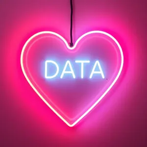 A pink neon heart with the word Data in the middle